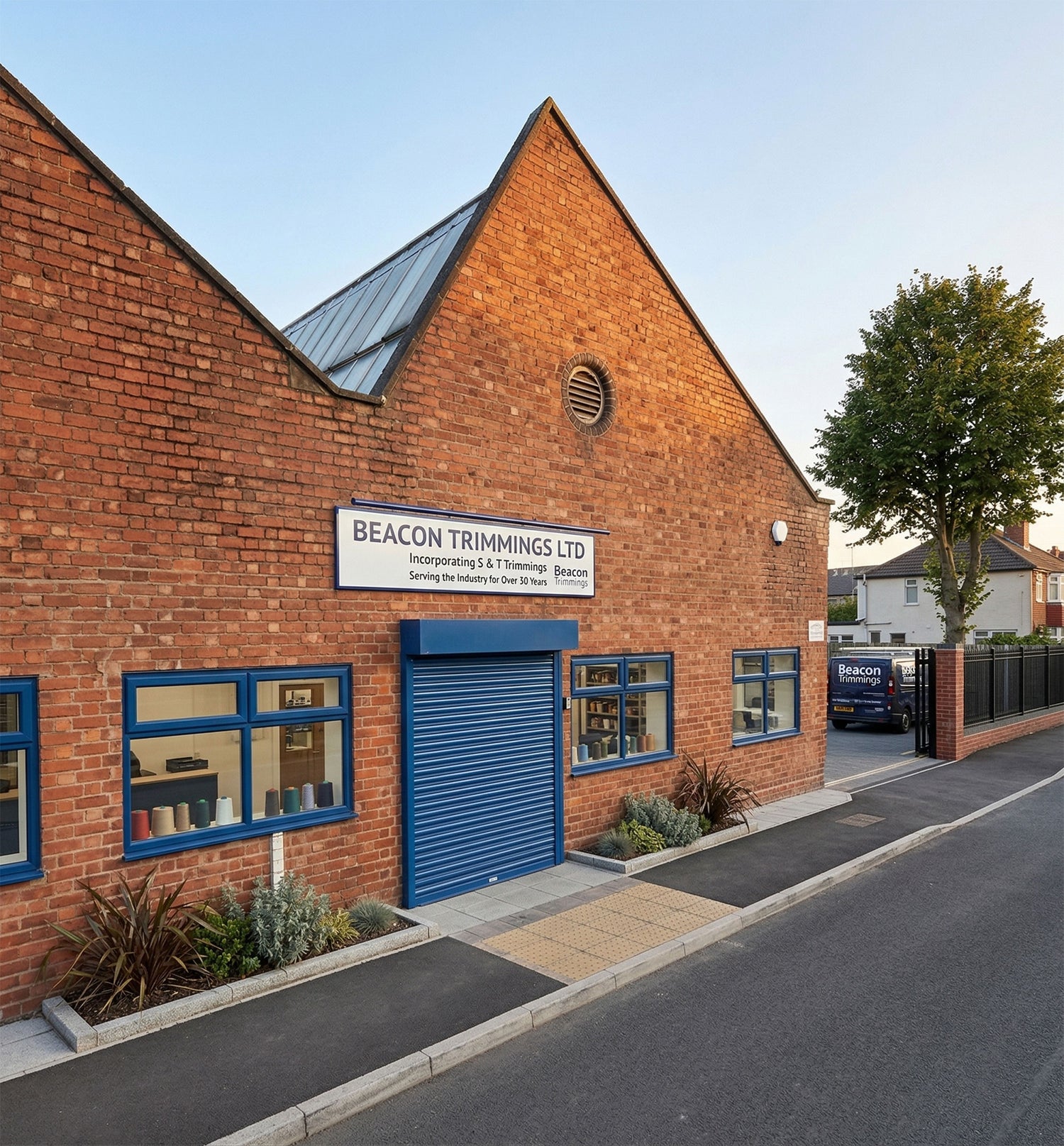 Beacon Trimmings Ltd brick building with blue windows and garage door, showcasing garment and upholstery supplies.