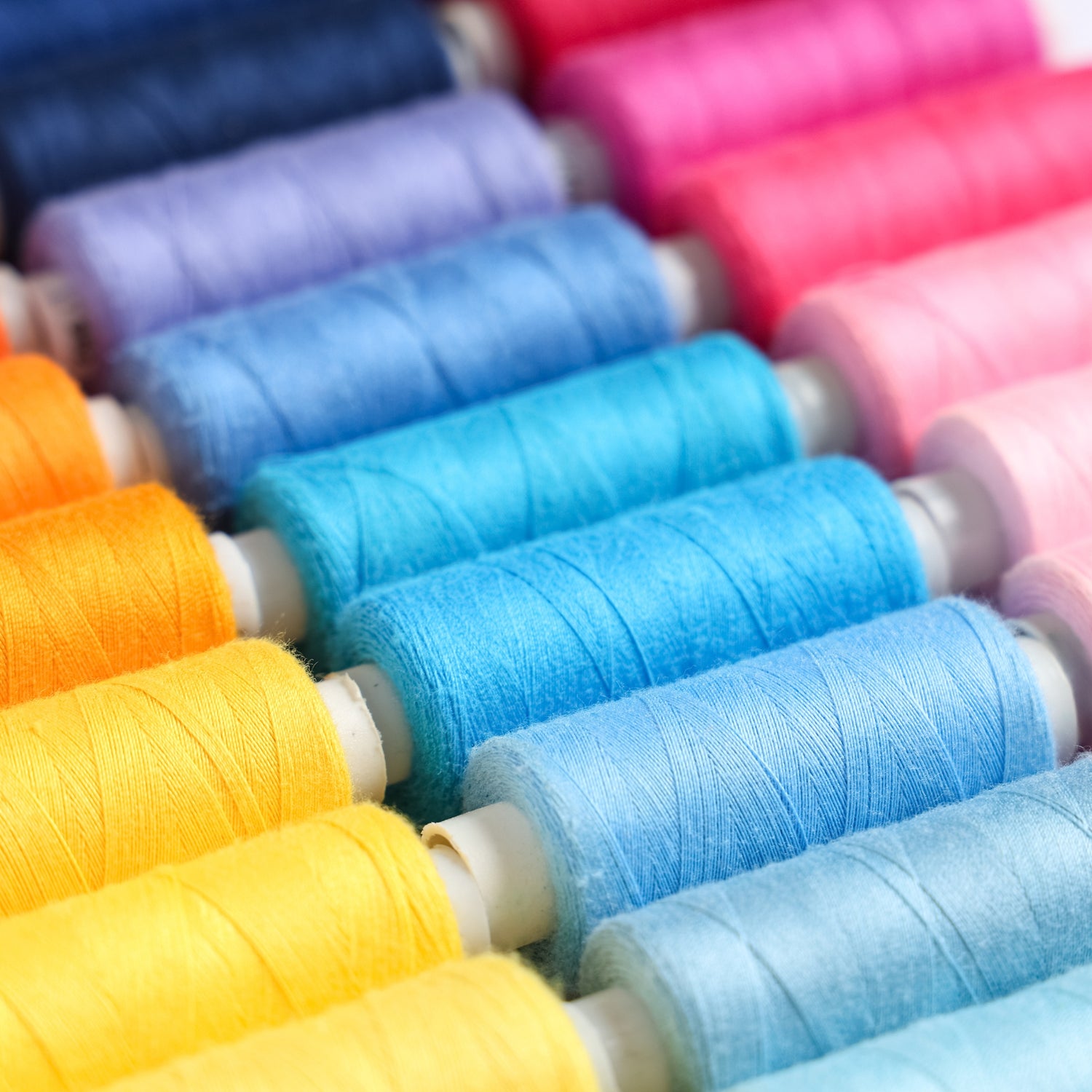 Colorful spools of sewing thread for garment and upholstery use