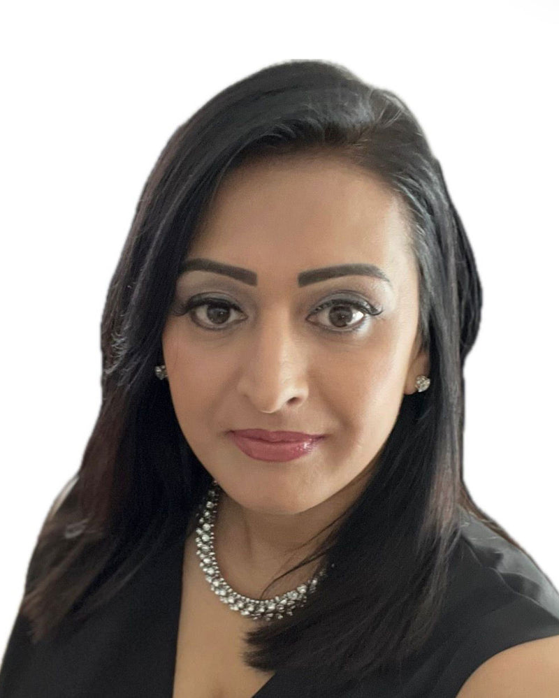 Professional woman with dark hair, wearing elegant necklace and earrings, dressed in black attire