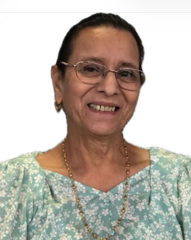 Smiling woman wearing glasses and floral blouse, representing Beacon Trimmings team