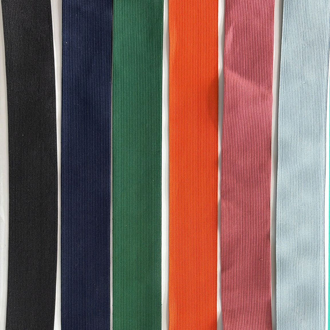 Colorful fabric trims for garment and upholstery use, featuring black, navy, green, orange, pink, and light blue.