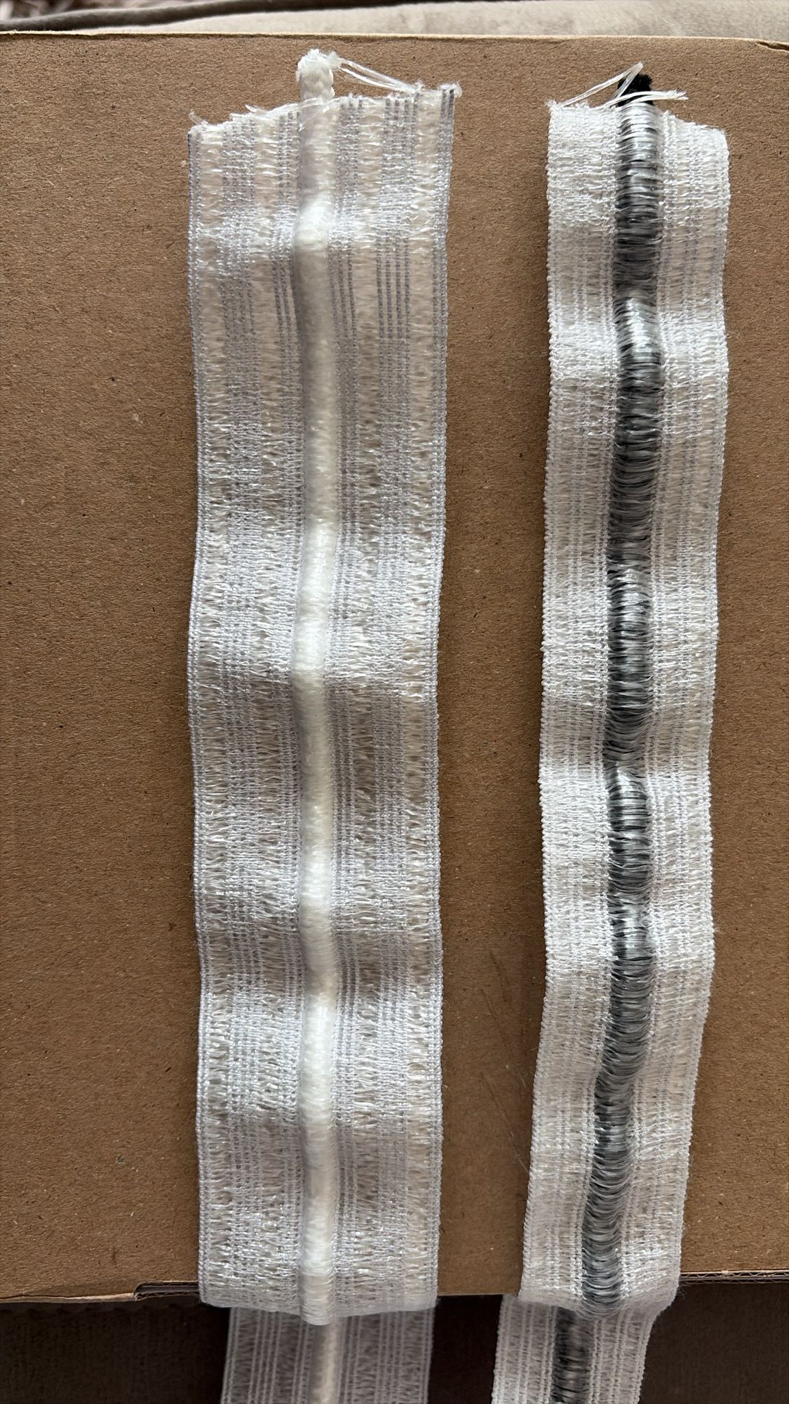 White and black fabric trim samples with textured edges for garment or upholstery use